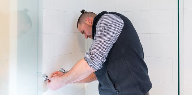 Plumber completing a shower installation